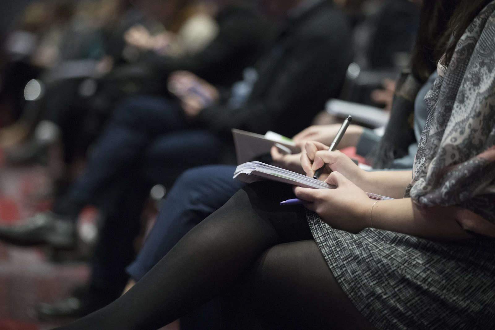 A participant taking notes during a parish formation session.